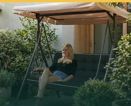 Relaxed summer patio with garden greenery and outdoor seating.