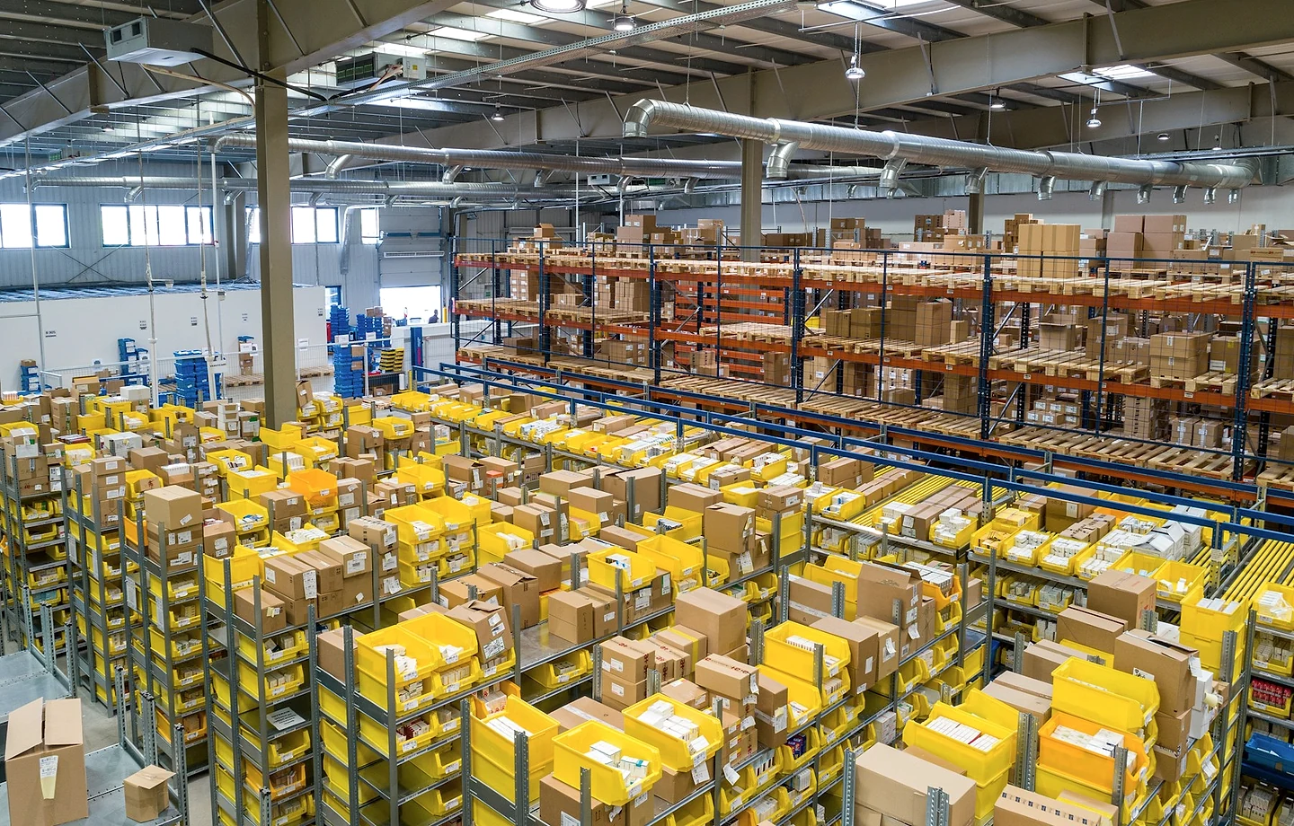 Organized wholesale warehouse with stocked shelves and parcels