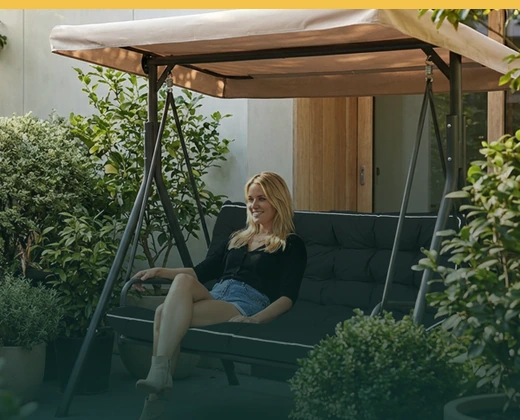 Relaxed summer patio with garden greenery and outdoor seating.
